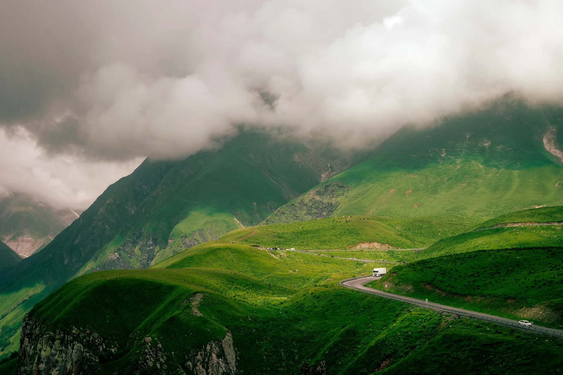 Winding mountain road through green hills